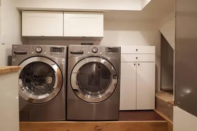 a kitchen with two washing machines in a kitchen at Private Suite Steps to Main St. in Vancouver