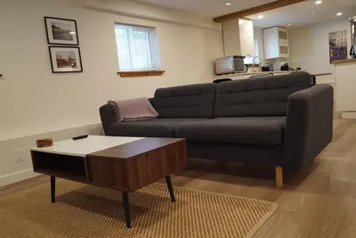 a living room with a couch and a coffee table at Private Suite Steps to Main St. in Vancouver