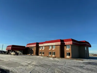 a building with a parking lot in front of it at The Viking Inn in Viking