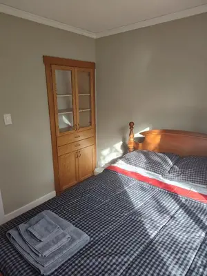 a bedroom with a bed with a towel on it at A Place to Call Home in Edmonton