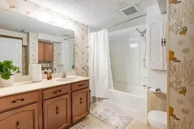 a bathroom with a sink and a tub and a shower at Simplistic 2BR Suite near Nose Hill & Airport in Calgary
