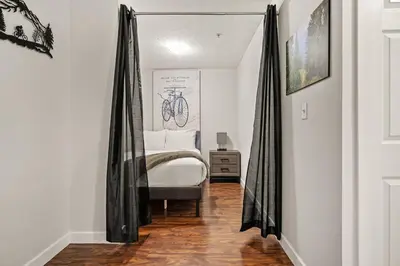 a bedroom with a bed with black drapes at Lakeside Memories, Pool, Hot Tub, Central in Invermere