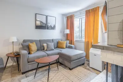 a living room with a couch and a tv at Whistler Studio by Gondola & Free Parking in Whistler