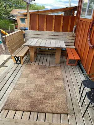 a wooden picnic table and benches on a deck at Mountain View Executive Suite in Grande Cache