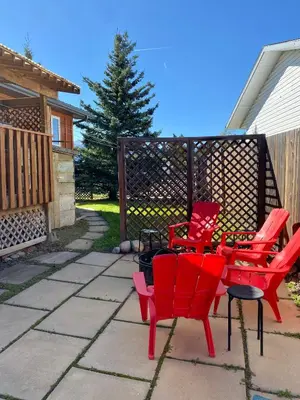 a group of red chairs sitting on a patio at Mountain View Executive Suite in Grande Cache
