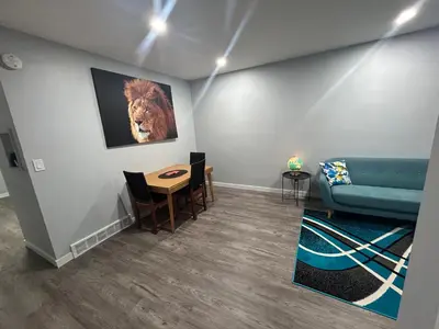 a living room with a couch and a table at Cute Highland Park Entire Unit A in Calgary