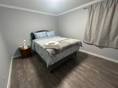 a small bedroom with a bed and a window at Cute Highland Park Entire Unit A in Calgary