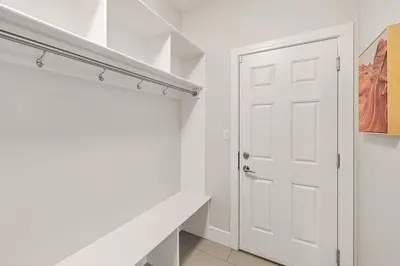a white closet with a white door in a room at Luxurious Entire House with Cental AC, Double Car Garage Parking, Upgraded Appliances, King Size Bed, Two Living Rooms & More in Nisku