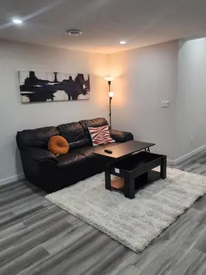 a living room with a couch and a coffee table at Trendy 2-Bed Oasis Awaits! in Calgary