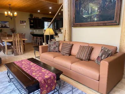 a living room with a couch and a table at Morrisey Chalet at Sun Peaks in Sun Peaks