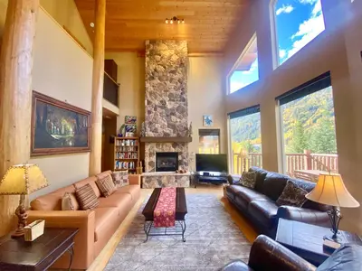 a living room with a couch and a fireplace at Morrisey Chalet at Sun Peaks in Sun Peaks