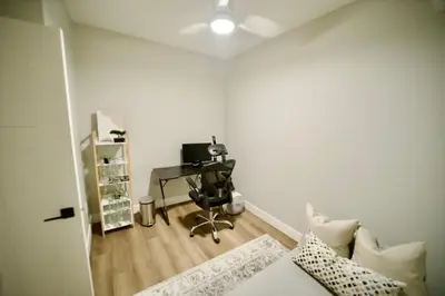 a room with a desk and a computer in it at Dreamy Panoramic Lakeview 1 Bedroom plus Den in Harrison Hot Springs