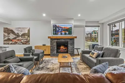 a living room with couches and a fireplace at Brand New - TimberLodge Spacious 2br in Canmore