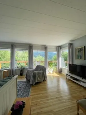 a living room with a couch and a television at Sweet Creek Retreat in Nelson