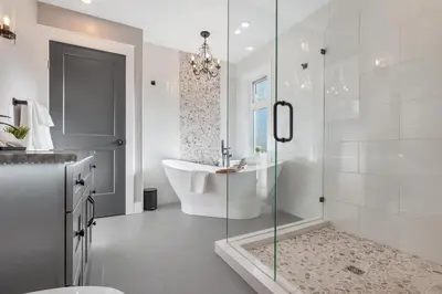 a bathroom with a tub and a glass shower at Vi Cottage in North Saanich