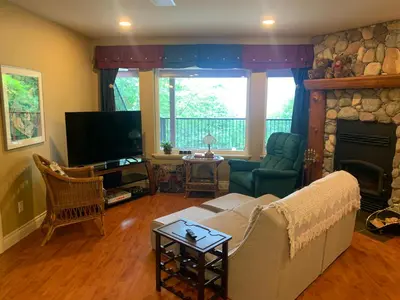 a living room with a couch and a fireplace at Shoreside Private room in Sechelt