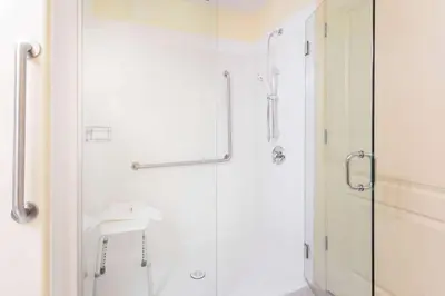 a bathroom with a shower and a sink at Ramada by Wyndham Hinton in Hinton