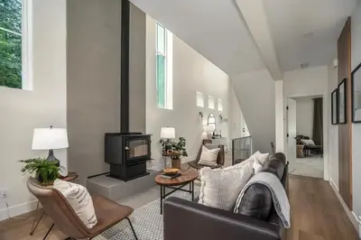 a living room with a couch and a fireplace at Black Diamond Cabin - Sasquatch Mountain Resort in Agassiz