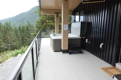 a bath tub sitting on the side of a house at Black Diamond Cabin - Sasquatch Mountain Resort in Agassiz