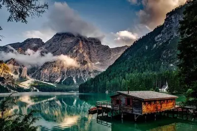 a cabin on a dock in the middle of a lake at Mountain Modern Hideaway in Canmore