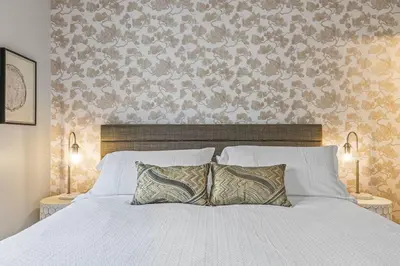 a bedroom with a white bed with two pillows at Mountain Vista Escape Downtown in Canmore