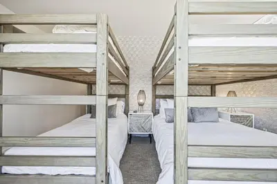 a bedroom with two bunk beds and a desk at Serenity Villa at Tamarack in Canmore