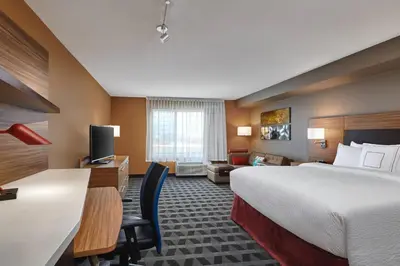a hotel room with a bed and a desk at TownePlace Suites by Marriott Fort McMurray in Fort McMurray
