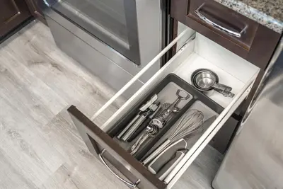 a sink in a drawer in a kitchen at UC Stampede Condo by Train, Hospital, free UG parking & Gym, AC, full kitchen in Calgary