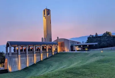 a building with a clock tower in the background at Kelowna family-friendly lake & Mountain view Luxury condo with AC, pool, Hot tub, near winery and shopping center in West Kelowna