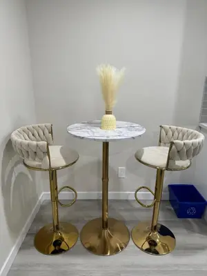 two chairs and a table with a vase on top of it at Brand new 2 Bedrooms modern guest suite with separate entrance in Calgary