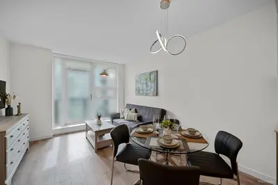 a living room with a table and a couch at Stylish and Tranquil Retreat in Richmond City Center in Richmond