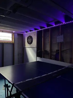 a ping pong table in a room with purple lights at Home in West Vancouver in West Vancouver
