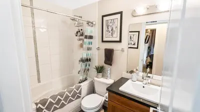 a bathroom with a toilet and a sink and a shower at Top Floor Lakeview Condo at Copper Sky 509 in West Kelowna