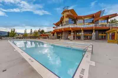 a large swimming pool in front of a building at Top Floor Lakeview Condo at Copper Sky 509 in West Kelowna