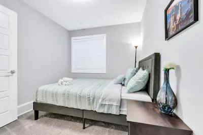 a bedroom with a bed and a vase on a table at Your Happy Place Seton3 bed. Sleeps 6. 2.5bath in Calgary