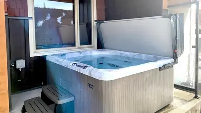 a jacuzzi tub in a room with a window at Powder Heights #22 townhouse in Sun Peaks