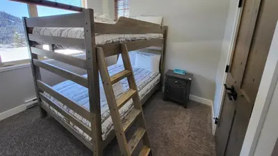 a couple of bunk beds in a room at Powder Heights #22 townhouse in Sun Peaks