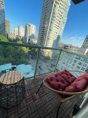 a balcony with two chairs and a view of a city at Luxury 2-bedroom condo beach side Yaletown in Vancouver