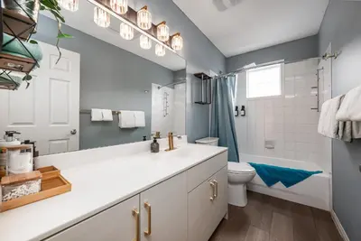 a bathroom with a sink and a toilet at Luxurious Retreat/Hot Tub/Mountain View/4 Beds in Canmore