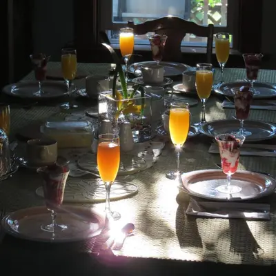 a table with glasses of orange juice on it at Phoenix House B&B in Stettler