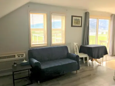 a living room with a couch and a table at D'Angelo Winery Farm House in Penticton