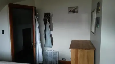 a bedroom with two dresses hanging on a wall at Bon Homme View in Jasper