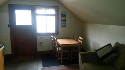 a room with a table and a door and a couch at Bon Homme View in Jasper