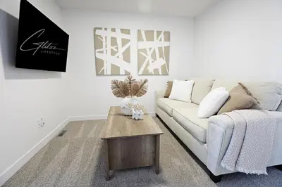 a living room with a couch and a coffee table at BoHo Retreat with King Beds, Golf, Disney+, Near WEM in Edmonton