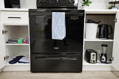 a black oven with a microwave on top of it at Stylish Retreat with King Bed, Long Stays, WEM, Disney+ in Edmonton