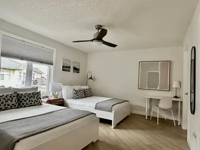 a bedroom with two beds and a ceiling fan at W411 NEW- TOP of the World Canmore MTN Retreat in Canmore