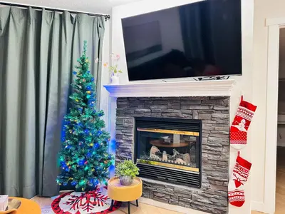 a living room with a christmas tree and a fireplace at W411 NEW- TOP of the World Canmore MTN Retreat in Canmore