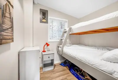 a bedroom with two bunk beds and a window at Family-friendly Cottage with amazing views in West Kelowna