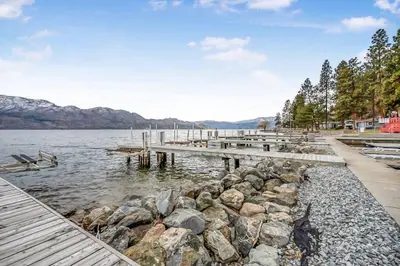 a dock on a body of water with rocks at Family-friendly Cottage with amazing views in West Kelowna
