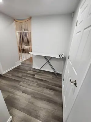 a room with a desk and a white door at Cozy one bedroom in Airdrie in Airdrie